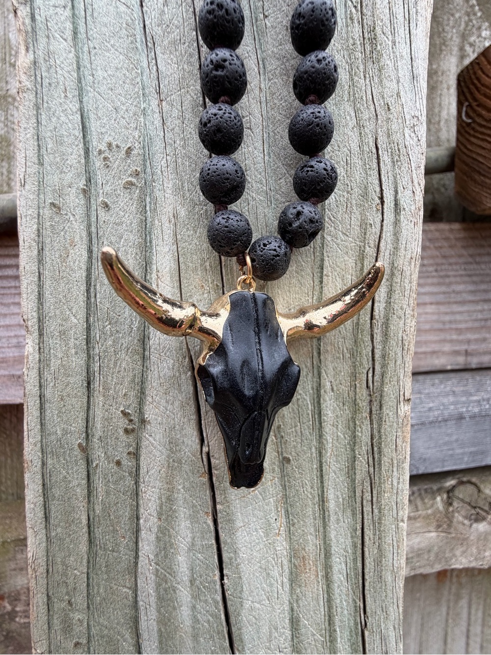 Black Lava Bead Necklace with Gold-Tipped Bull Skull Pendant